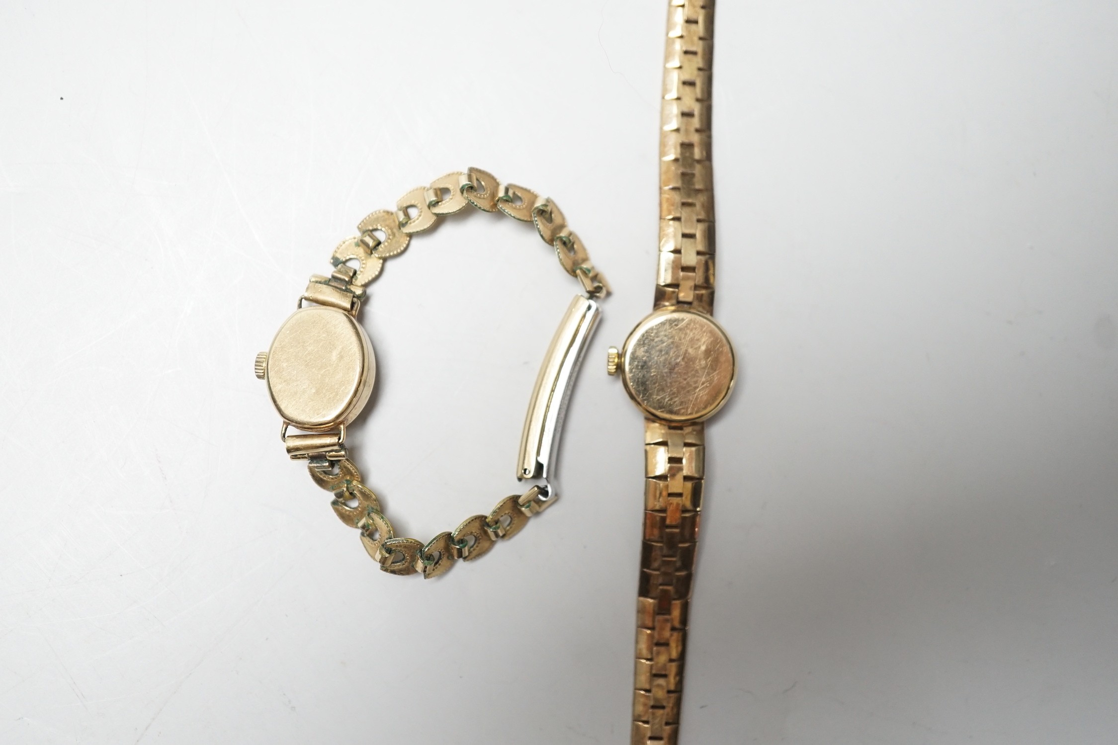 A lady's 9ct gold Omega manual wind wrist watch, on associated 9ct gold bracelet, overall 15.8cm, gross weight 17.8 grams and one other lady's 9ct gold watch on a gold plated bracelet.